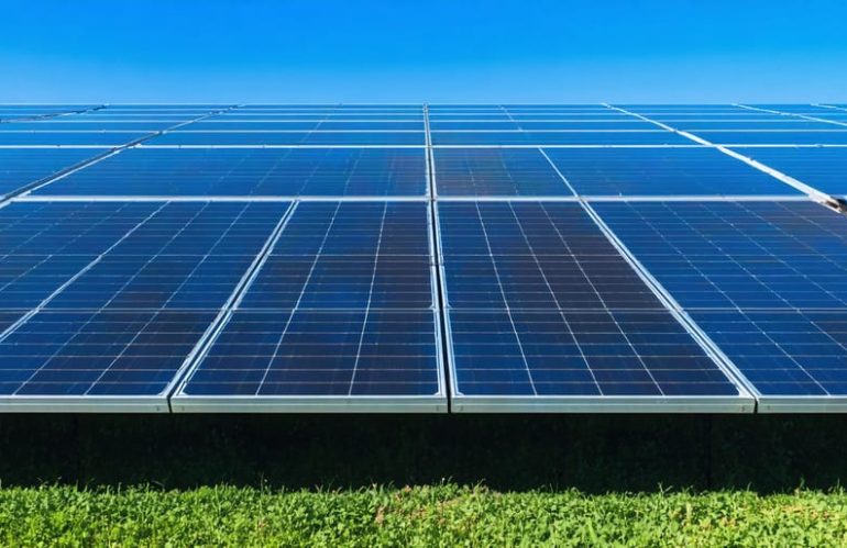Diverse community members actively collaborating and discussing solar energy projects amidst a vibrant neighborhood backdrop.