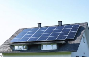 Illustration of a residential house with multiple solar panels of varying sizes installed on the roof, with each panel's dimensions visibly labeled to highlight the importance of size in solar energy systems.