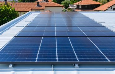 "Aerial view of a residential rooftop with a modern installation of solar panels, showcasing secure mounts and clean design under soft natural daylight."