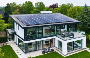 "A modern home featuring rooftop solar panels and integrated smart technology in a sustainable environment."